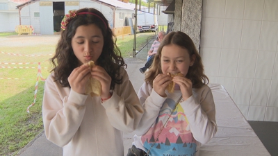 Dúas rapazas proban os freixós elaborados no recinto feiral de Muimenta