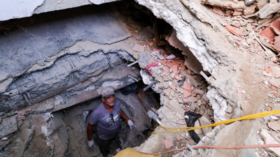 Un home fai un tunel para buscar os corpos da súa filla e o seu xenro en La Guaira. REUTERS/Gaby Oraa